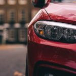 red car in front of building during daytime