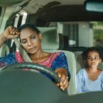 a woman and a child sitting in a car